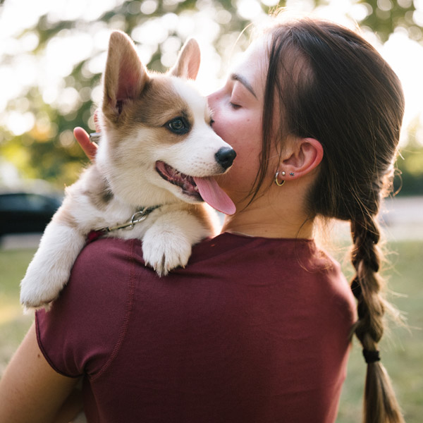 woman holding dog outside