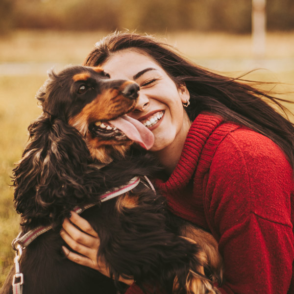 woman playing with dog outside