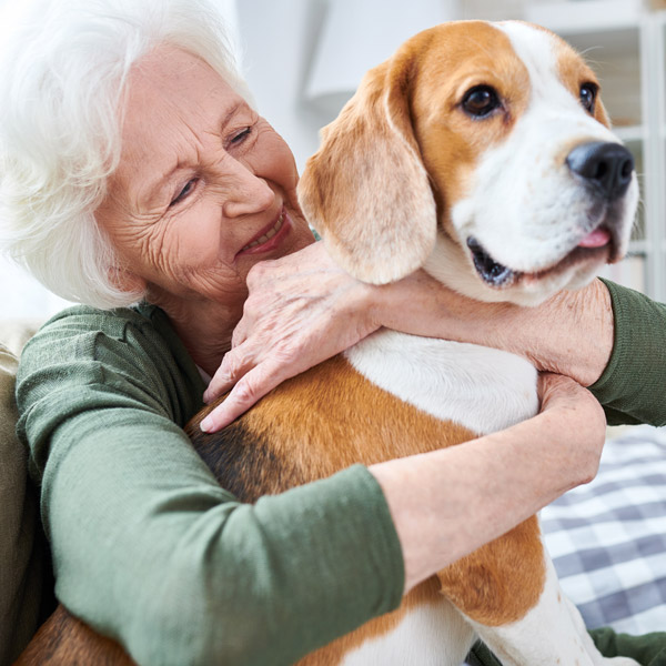 mature woman holding dog